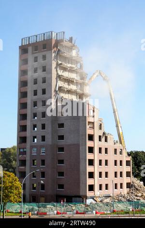 High rise block of flats, Irvine, Ayrshire, Scotland, UK, being demolished by a mechanical crane. Stock Photo