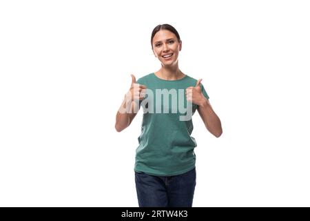 young joyful positive black-haired woman in a green basic t-shirt shows class Stock Photo