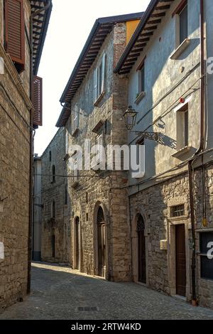A glimpse of medieval Ascoli Piceno with narrow streets between tall stone buildings. Ascoli Piceno, Marche region, Italy, Europe Stock Photo