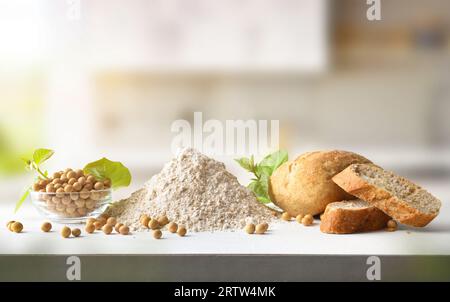 Detail of alternative bread with soy flour on white bench and background kitchen. Front view. Stock Photo