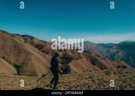 November 30th 2022. Tehri Garhwal, Uttarakhand India. A lone hiker in the Himalayas of Uttarakhand, using a walking stick, embarking on an exploration Stock Photo