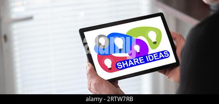 Share ideas concept shown on a tablet held by a man Stock Photo