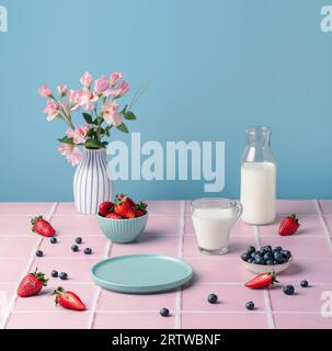 Healthy food. Table setting with berries strawberries glass of milk. Stock Photo