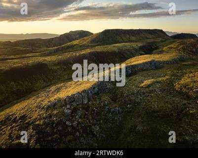 Mountainous terrain with dry grass and rocky slopes Stock Photo