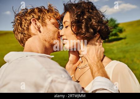 Interracial Married Couple Kissing In A Park; Edmonton, Alberta, Canada