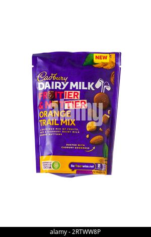 Bag of Cadbury Dairy Milk Fruitier & Nuttier Orange Trail Mix a delicious mix of fruits, nuts & Cadbury Dairy Milk orange buttons isolated on white Stock Photo