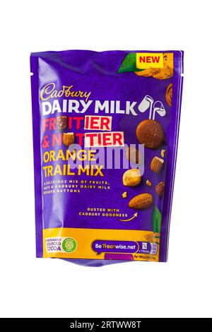 Bag of Cadbury Dairy Milk Fruitier & Nuttier Orange Trail Mix a delicious mix of fruits, nuts & Cadbury Dairy Milk orange buttons isolated on white Stock Photo