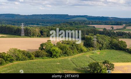 Aerial landscape shot of the countryside near the village of west Compton in West Sussex. Electricity pylons crossing the land. Stock Photo