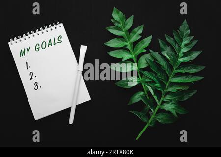 notebook with goals on black table, flat lay style Stock Photo
