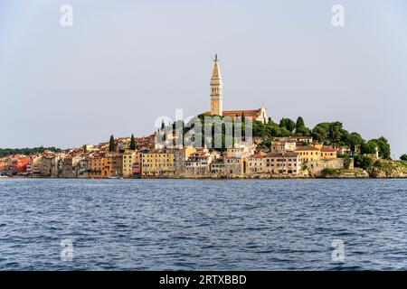 View at sundown of the historic waterfront, with the Church of Saint Euphemia on the hill above, in Rovinj on the Istrian Peninsula of Croatia Stock Photo