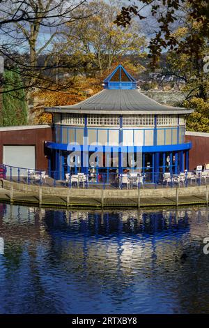 Circular Cafe and Boating Pavilion reflecting on the boating lake on a sunny autumn day, Lister Park, Bradford, West Yorkshire, England,UK. Stock Photo