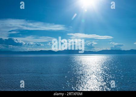 Sunlight glittering on the blue water of Khovsgol Lake, the largest freshwater lake in Mongolia on a bright summer day Stock Photo