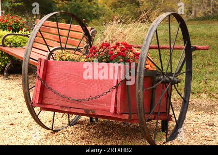 Red Vintage Wheelbarrow Planter Stock Photo
