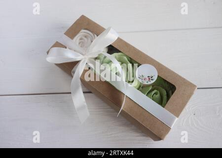 Homemade marshmallows in a paper gift boxes. Zephyr flowers. The boxes is tied with a ribbon tied into a bow. Stock Photo