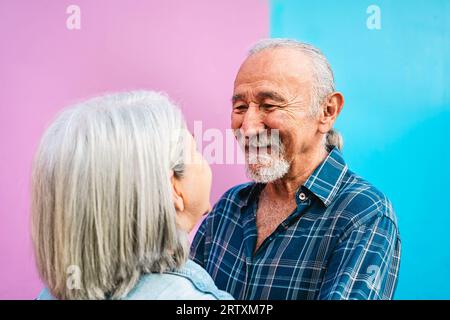 Happy senior couple having tender moments outdoor - Elderly people and love relationship concept Stock Photo