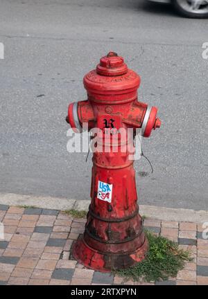 Fire hydrant. a red fire hydrant in the street. Fire hydrant for emergency fire access on street in veliko tarnovo, bulgaria Stock Photo