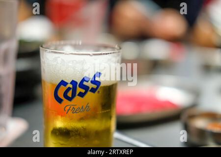 Bangkok, Thailand - 8 May 2022: A Glass of Cass Fresh, a lager style beer brewed by Oriental Brewery Co., Ltd in Seoul, South Korea. It's famous for y Stock Photo