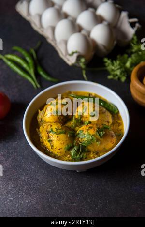 Indian style egg masala in mustard sauce served in a bowl. Close up, selective focus. Stock Photo