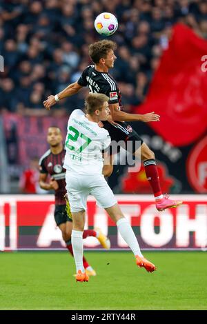 Nuremberg, Germany. 15th Sep, 2023. Soccer: 2nd Bundesliga, 1. FC Nürnberg - SpVgg Greuther Fürth, Matchday 6, Max Morlock Stadium. Nuremberg's Benjamin Goller (top) and Fürth's Gian-Luca Itter in action. Credit: Daniel Löb/dpa - IMPORTANT NOTE: In accordance with the requirements of the DFL Deutsche Fußball Liga and the DFB Deutscher Fußball-Bund, it is prohibited to use or have used photographs taken in the stadium and/or of the match in the form of sequence pictures and/or video-like photo series./dpa/Alamy Live News Stock Photo