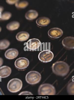 Vintage typewriter with Cyrillic alphabet characters keyboard, writing text letter on empty page sheet of craft paper, old-fashioned writer machine, v Stock Photo