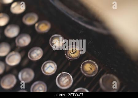 Vintage typewriter with Cyrillic alphabet characters keyboard, writing text letter on empty page sheet of craft paper, old-fashioned writer machine, v Stock Photo