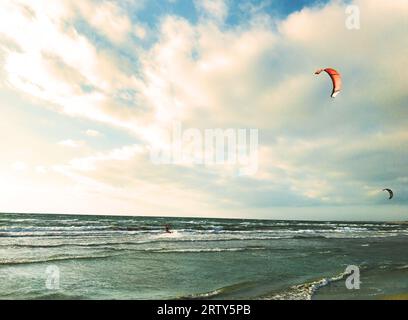 kite surfers rushing at stormy sea Stock Photo