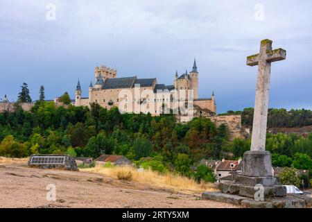 Segovia, Spain. September 15, 2022 -Alcazar of Segovia on the rocky hill with cliffs, from the stone cross next to the Templar church in the valley Stock Photo