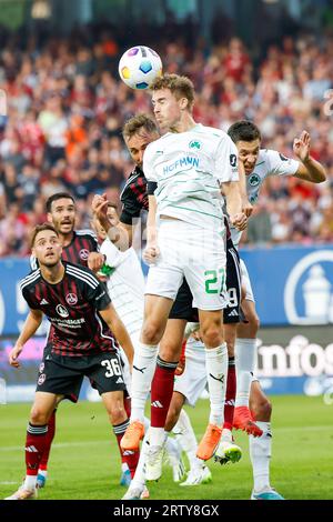 Nuremberg, Germany. 15th Sep, 2023. Soccer: 2nd Bundesliga, 1. FC Nürnberg - SpVgg Greuther Fürth, Matchday 6, Max-Morlock-Stadion. Fürth's Gian-Luca Itter (front) clears a cross with a header. Credit: Daniel Löb/dpa - IMPORTANT NOTE: In accordance with the requirements of the DFL Deutsche Fußball Liga and the DFB Deutscher Fußball-Bund, it is prohibited to use or have used photographs taken in the stadium and/or of the match in the form of sequence pictures and/or video-like photo series./dpa/Alamy Live News Stock Photo