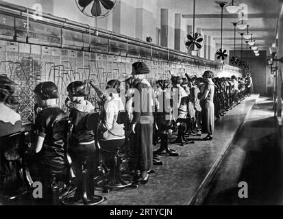 United States:  c. 1923. Bell System telephone operators who manually connected most telephone calls. Dial equipment was first introduced in 1919. Stock Photo