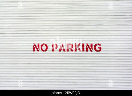 No Parking painted in red letters on a garage door, UK Stock Photo