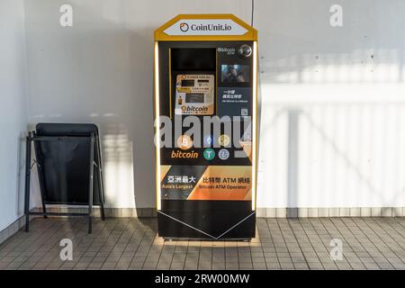 Bitcoin vending machine on the street on a sunny day. Hong Kong - 30th August 2023 Stock Photo