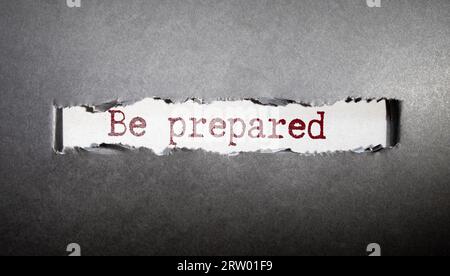 BE PREPARED, message on business card shown by a man, vintage tone. Stock Photo