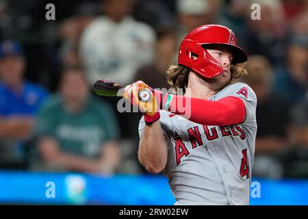 Los Angeles Angels' Brett Phillips fields a base hit by Texas Rangers'  Bubba Thompson during the xx inning of a spring training baseball game,  Saturday, March 18, 2023, in Tempe, Ariz. (AP