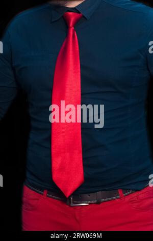 Red tie men's style and fashion with blue shirt and pants. Stock Photo