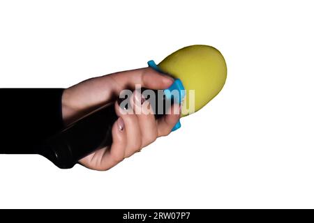 Female hand close-up holding microphone professional karaoke singing equipment on white background isolated. Stock Photo