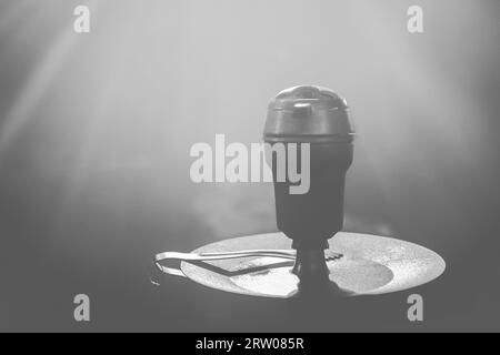 Clay object hookah head smoking on a black background in orange and blue  neon light color Stock Photo - Alamy