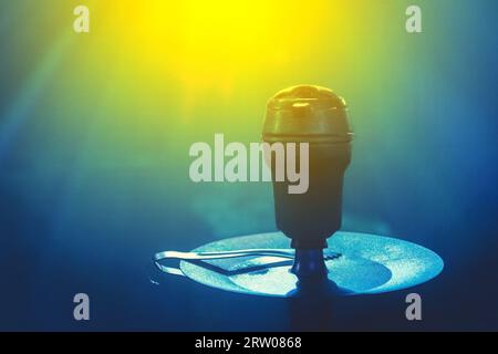 Hookah head bowl smoking object in blue glare light close-up. Stock Photo