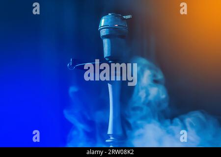 https://l450v.alamy.com/450v/2rw08k2/hookah-head-clay-bowl-and-pipe-smoking-object-in-smoke-and-blue-and-orange-glare-light-relaxation-atmosphere-2rw08k2.jpg