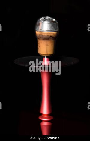 Clay object hookah head smoking on a black background Stock Photo