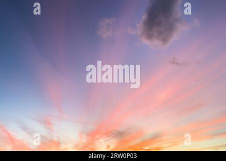 Radially arranged clouds Veil clouds Cirrostratus are colourfully illuminated by the setting sun Evening sun, Germany Stock Photo