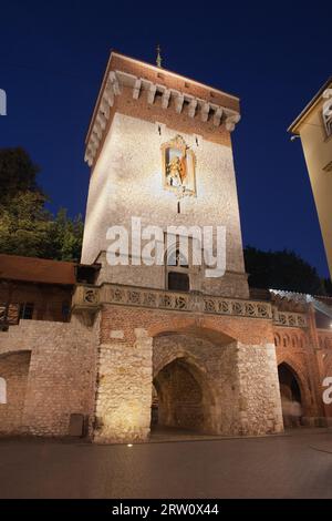 St. Florian's Gate or Florian Gate (Polish: Brama Florianska) at night in the Old Town of Krakow in Poland. 14th century Gothic style city wall Stock Photo