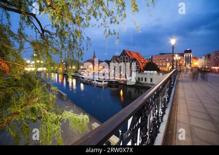 Bydgoszcz city skyline at night in Poland with old Granaries and bridge at river Brda Stock Photo
