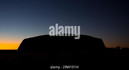 Majestic Uluru at sunrise on a clear winter's morning in the Northern Territory, Australia Stock Photo