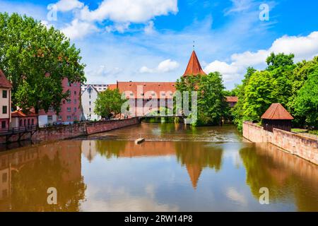 Fronveste bridge through Pegnitz river and Schlayerturm tower in Nuremberg old town. Nuremberg is the second largest city of Bavaria state in Germany. Stock Photo