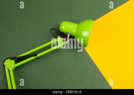 Table lamp with a beam of light directed at a small plant. The beam embodies the idea. High quality photo Stock Photo