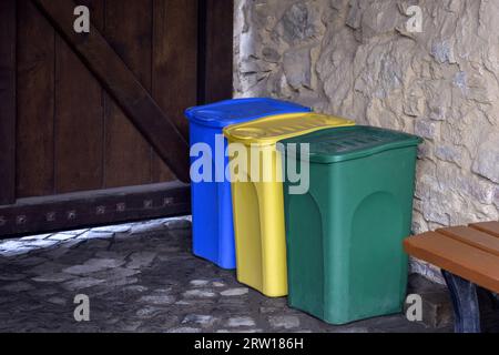 Multi-colored plastic containers for separate garbage collection. The concept of environmental protection from pollution. Copy space. Selective focus. Stock Photo