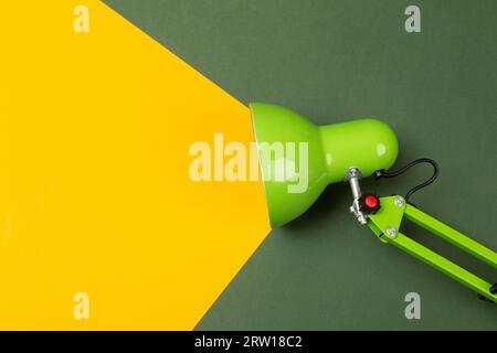Table lamp with a beam of light directed at a small plant. The beam embodies the idea. High quality photo Stock Photo