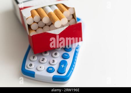 Cigarettes in an open red and white pack on a light table Stock Photo