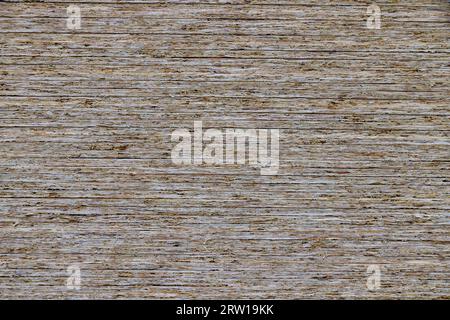 full-frame background and flat texture of stack of OSB compressed sawdust sheets. Stock Photo