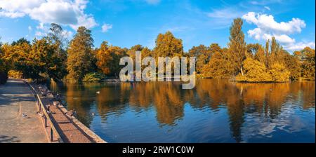 Panoramic view of Kelsey public park with foliage trees reflected in the lake in fall season - Beckenham village, London Stock Photo